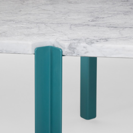 Details of the Quattro Cantoni coffee table in brushed matte Carrara marble and turquoise legs